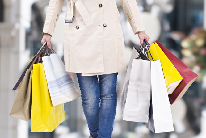 Woman holding many shopping bags